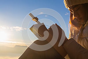 Women pray to God with the Bible and the cross on the mountain background with morning sunrise. Woman Pray for god blessing to photo