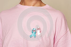 women promoting breast cancer for men and women with pink shirt and ribbons