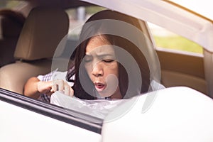 Woman puke or vomiting into plastic bag in car,Car Sick and motion sickness photo