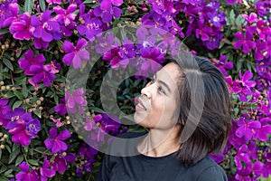 Women and Purple flower or Tibouchina granulosa in garden. photo