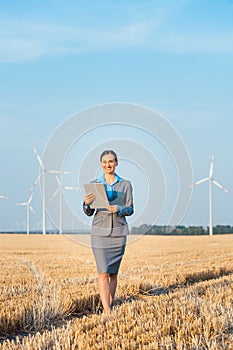 Women putting money into an ethical Investment of wind turbines