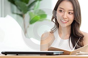 Women read book to learning on bed in bed room in the morning