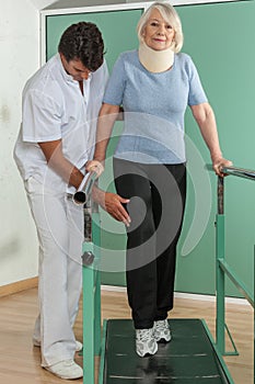 Women rehabilitating her legs with his doctor photo