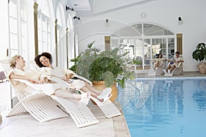 Women Relaxing Around Pool At Spa