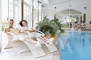 Women Relaxing Around Pool At Spa