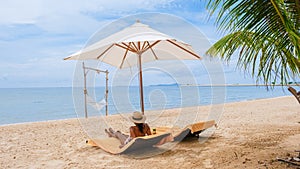 Women relaxing on a beach chair sunny day with hammock on beach in Pattaya Thailand Ban Amphur beach