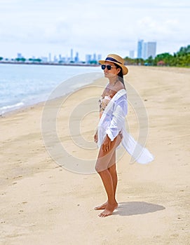 Women relaxing on a beach chair sunny day with hammock on beach in Pattaya Thailand Ban Amphur beach