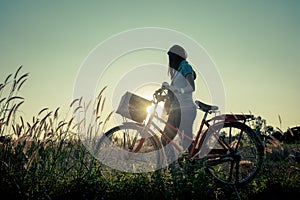 Women relaxing with a bike in nature
