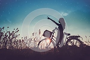 Women relaxing with a bike in nature