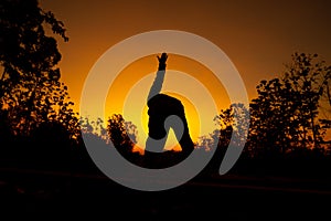 Women relaxing and exercising on moning of sihouette sky background