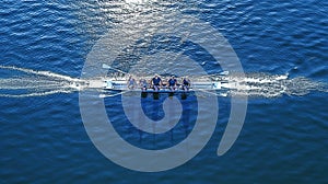 Women rowing team on blue water, Generative AI