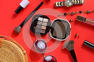 Women`s accessories and background for girls. Women bag, watches, and cosmetics. Red background, styling photography and creative