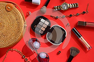 Women`s accessories and background for girls. Women bag, watches, and cosmetics. Red background, styling photography and creative