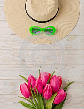 Women`s accessories - a hat, sunglasses and shoes. A bouquet of