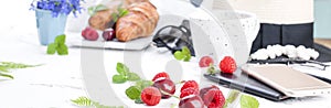 Women`s accessories, lady on vacation. Sunglasses and hat, croissant and coffee for breakfast. White background. Copy space. Flat