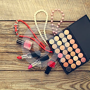 Women`s accessories necklace, nail polish, lipstick, hair clip, eye shadow.