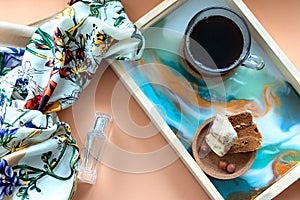 Women`s accessories - perfume, scarf, cup of coffee with biscuit on tray. Mockup for elegant concept. Flat lay, top view, copy