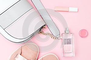 Women`s accessories and perfumes of pink color on a pink backgro