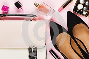 Women`s accessories - shoes, bag, cosmetics, perfume on pink bac