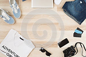 Women`s accessories, summer casual clothes on a wooden background. Vacation and travel items.