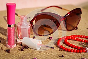 Women's accessories sunglasses, lip gloss, nail polish, beads