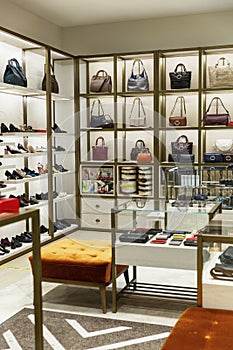 Women`s bags, shoes and accessories on the shelves in the store. Modern stylish fashion. Vertical