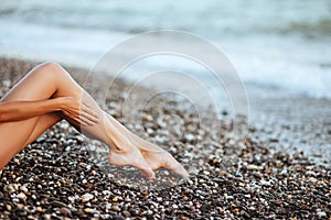 Women`s beautiful legs on the beach