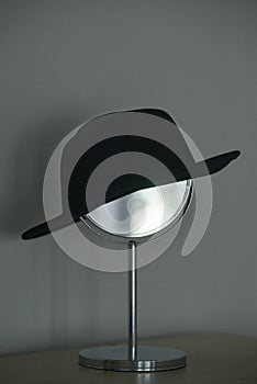 Women's black hat is placed on the make-up mirror
