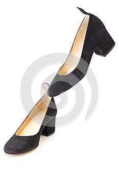 Women`s black shoes with heels on a white background