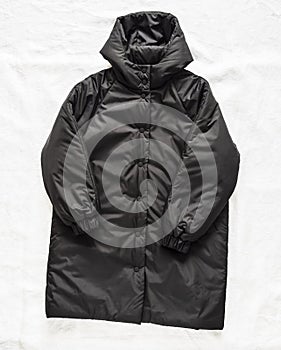 Women\'s black warm winter jacket, coat, parka on a light background, top view