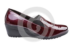 Women`s burgundy patent leather shoes, high-soled, on a white background