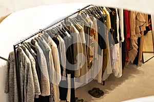Women's casual demi - season clothes on a hanger in the shop