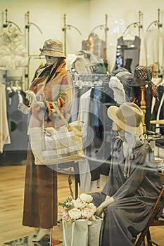 Women& x27;s clothing boutique with mannequins. Blurred view through shop window. Seasonal sale, shopping concept