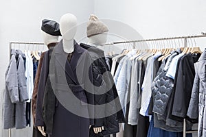 Women`s clothing boutique with mannequins showing the autumn-winter collection. Fashion & Style