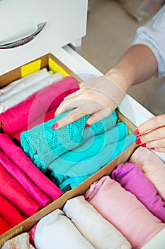 Women`s clothing in the drawers of the wardrobe. Underwear, T-sh