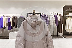 Women's clothing on hangers in a boutique. Fashion, style and beauty. Warm jackets for the winter season