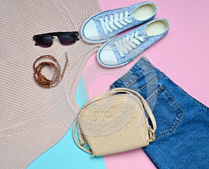 Women& x27;s clothing, shoes and accessories on a blue pink pastel background. Fashionable look.