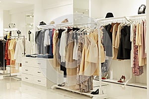 Women`s clothing store interior. Large selection of fashionable dresses