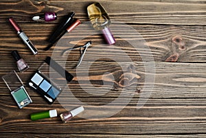 Women& x27;s cosmetics for make-up, objects for care of nails and perfumes lie on a wooden table.