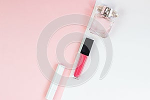 Women`s cosmetics on a pink white background. Lipstick and perfume, beauty and fashion concept. Top view, flat lay, copy space,