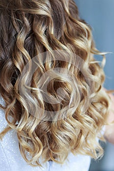 Women`s curls in a professional wedding hairstyle photo
