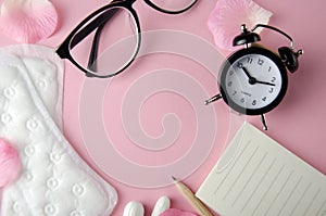 Women`s cycle hyhienic pads and tampons on pink background. Copy space