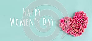 Women`s day banner.postcard favorite.Festive wreath of roses decoration with gifts and pink roses on a blue background