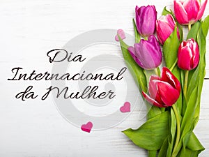 Women`s day card with Portuguese words `DÃÂ­a Internacional da Mulher`. photo