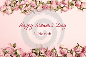Women`s Day greeting message with small dry roses on pink backgr