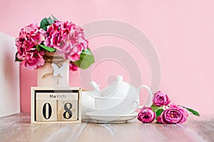 Women`s Day. March 8 tree calendar, International Women`s Day, decorated with pink and purple flowers on a pink background