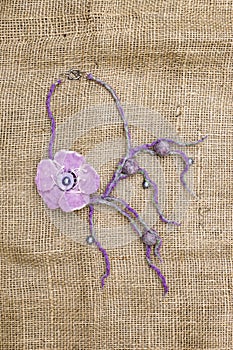 Women`s decoration of felted wool on burlap.