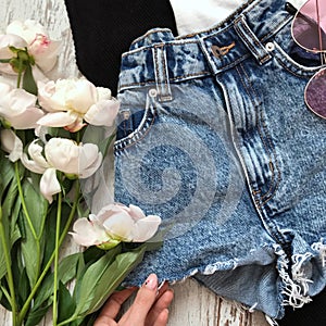 Women`s denim shorts on a wooden background