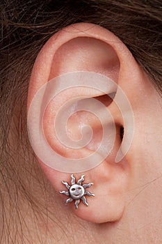 Women's ear with an earring