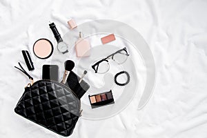 Women`s fashion. Black handbag, makeup brushes, cosmetics, sunglasses, accessories on white background. social media